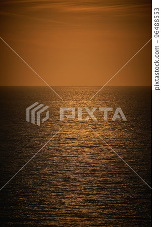 A vertical photograph of a moody dark orange sea view A vertical photograph of a moody dark orange sea view 96488553