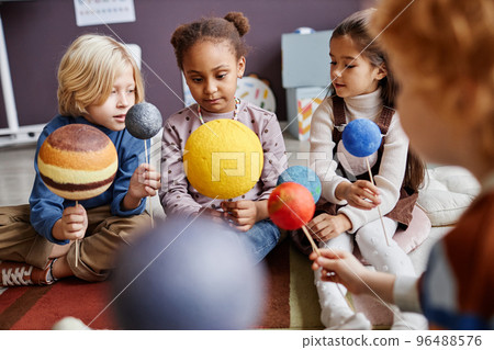Cute little learners of primary school studying astronomy 96488576