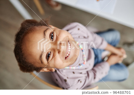 Above shot of face of happy little learner of nursery school Above shot of face of happy little learner of nursery school 96488701