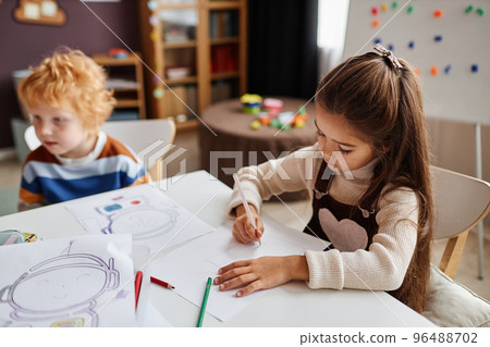 Little learner of nursery school drawing picture on paper Little learner of nursery school drawing picture on paper 96488702