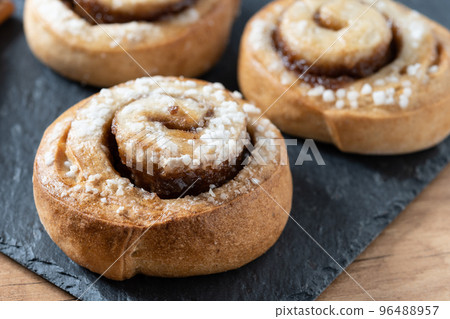 Cinnamon rolls buns on wooden table. Kanelbulle Swedish dessert 96488957