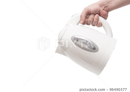 Hand holding a white electric kettle. Close up. Isolated on a white background. 96490377