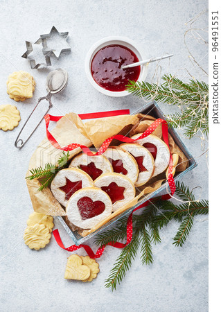 Classic Linzer Christmas Cookies with raspberry or strawberry jam on light background. Classic Linzer Christmas Cookies with raspberry or strawberry jam on light background. 96491551