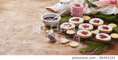Classic Linzer Christmas Cookies with raspberry or strawberry jam on wooden table Classic Linzer Christmas Cookies with raspberry or strawberry jam on wooden table 96491583