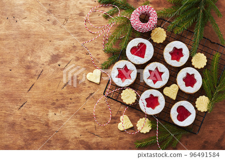 Classic Linzer Christmas Cookies with raspberry or strawberry jam on wooden table Classic Linzer Christmas Cookies with raspberry or strawberry jam on wooden table 96491584