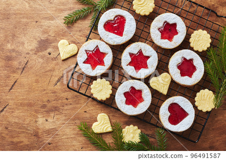 Classic Linzer Christmas Cookies with raspberry or strawberry jam on wooden table Classic Linzer Christmas Cookies with raspberry or strawberry jam on wooden table 96491587