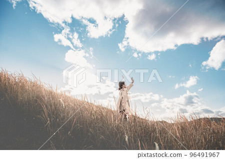 Blue sky, autumn meadow and woman Blue sky, autumn meadow and woman 96491967