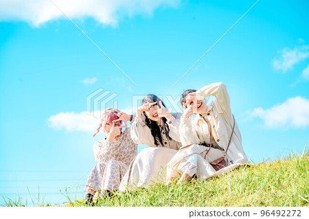 Women looking happy under the blue sky 96492272