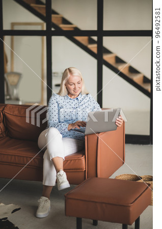Blonde woman working on the laptop 96492581