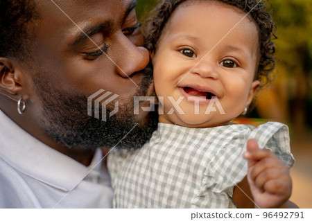 Loving dad giving a kiss to his petty child Loving dad giving a kiss to his petty child 96492791