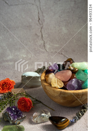 various gem stones in a wooden bowl various gem stones in a wooden bowl 96493334