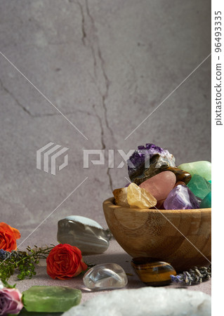 various gem stones in a wooden bowl various gem stones in a wooden bowl 96493335