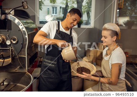 Two smiling happy roast masters working together 96493510