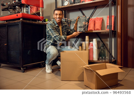 Joyous barista making a customer order ready for delivery 96493568