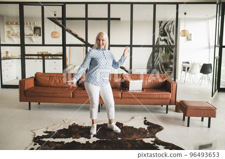 Blonde woman feeling excited and looking energized 96493653