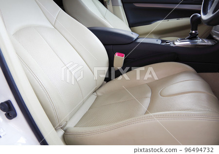 Bright beige genuine leather seats of a passenger car about 10 years old Bright beige genuine leather seats of a passenger car about 10 years old 96494732