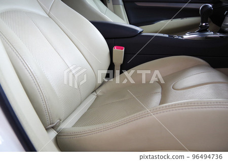 Bright beige genuine leather seats of a passenger car about 10 years old Bright beige genuine leather seats of a passenger car about 10 years old 96494736