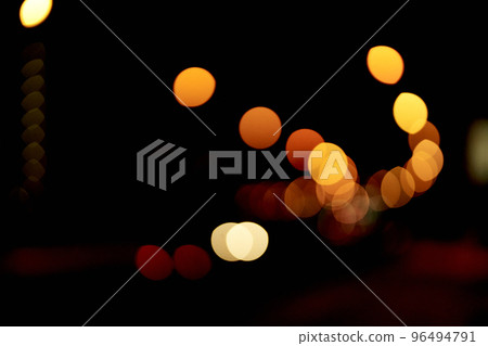 Golden defocused bokeh lights on an isolated black background. Abstract magic background with bokeh effect, golden glitter for Christmas. Overlay for your design.High quality photo 96494791