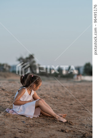 Two European girls enjoy the sunset on the sea, play, hug, smile. Love sisters on the beach. as a gift from daughters mother's day. Family vacation at the hotel. Happy childhood in summer. High 96495176