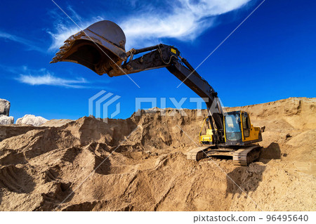 Yellow excavator working with sand at construction site Yellow excavator working with sand at construction site 96495640