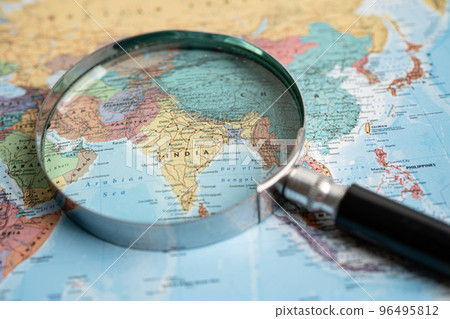Bangkok, Thailand - May 01, 2022 India, Magnifying glass close up with colorful world map. 96495812
