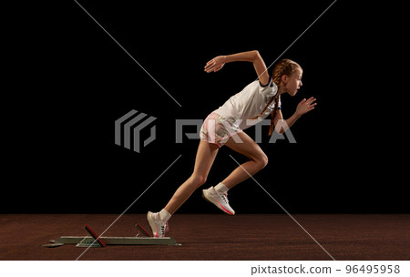 Focus on movement. Portrait of begginer athlete, runner training isolated on black studio background. Concept of action, motion, speed, healthy lifestyle. Focus on movement. Portrait of begginer athlete, runner training isolated on black studio background. Concept of action, motion, speed, healthy lifestyle. 96495958