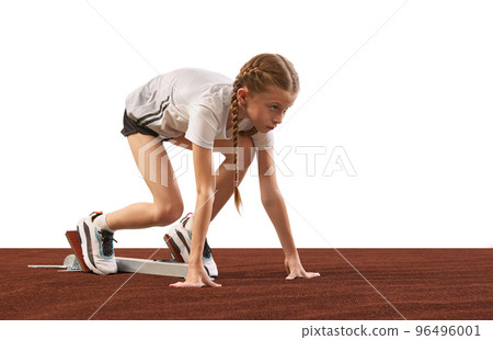 School age girl, junior runner or jogger at starting position ready to start a race. Concept of energy, action, motion, kids achievements 96496001