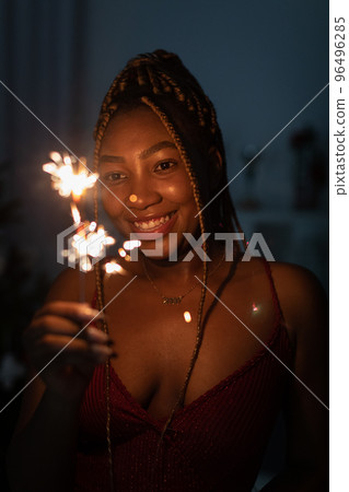 The joy of an African woman during the burning of cold fires. New Year. The joy of an African woman during the burning of cold fires. New Year. 96496285