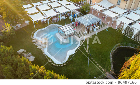 aerial drone view Wedding party at villa with pool location in Piacenza Italy aerial drone view Wedding party at villa with pool location in Piacenza Italy 96497166