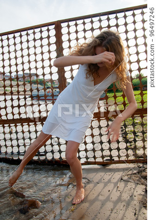 Youbg laughing woman near grid fence 96497246