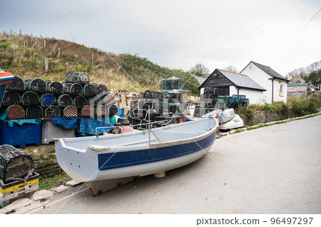 Fishing boats in seaside village near Lulworth Cove in Dorset, United Kingdom. Cloudy autumn day Fishing boats in seaside village near Lulworth Cove in Dorset, United Kingdom. Cloudy autumn day 96497297