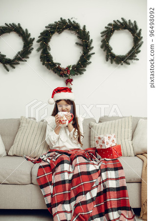 Little girl spends time in the holiday room 96498092