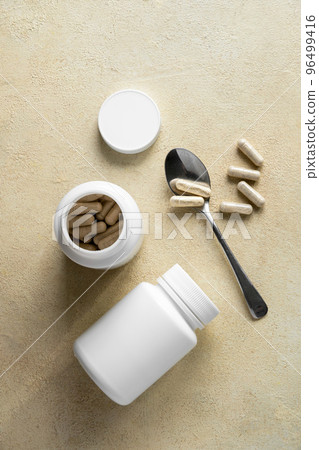 White pill bottles on warm background. Health care food supplements, vitamins and medicaments 96499416