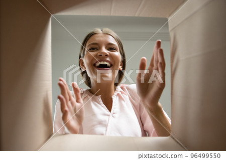 Happy laughing young woman getting order from internet store. Happy laughing young woman getting order from internet store. 96499550