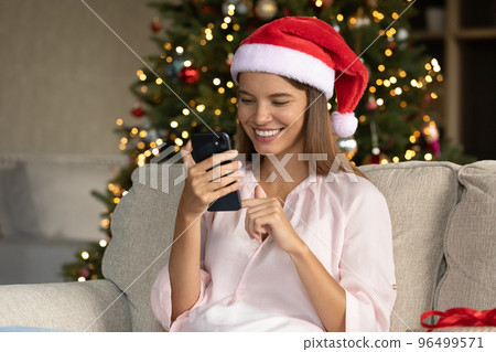 Happy young attractive woman congratulating friends online. 96499571