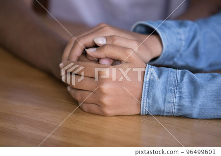Loving girlfriend touches hand of beloved boyfriend, closeup 96499601