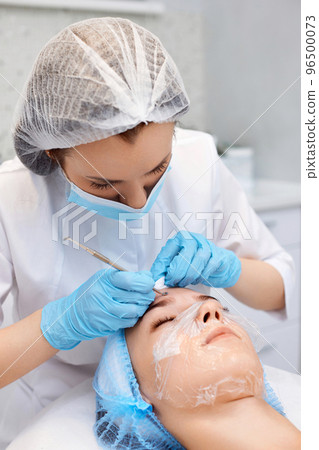 woman during a mechanical face cleansing procedure woman during a mechanical face cleansing procedure 96500073
