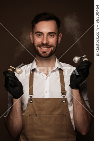 Manicur master man in working form with tools in hand. Nail photo content Manicur master man in working form with tools in hand. Nail photo content 96500464