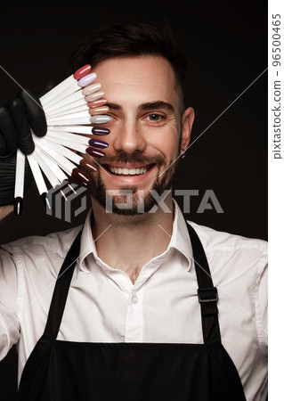 Manicur master man in working form with tools in hand. Nail photo content Manicur master man in working form with tools in hand. Nail photo content 96500465