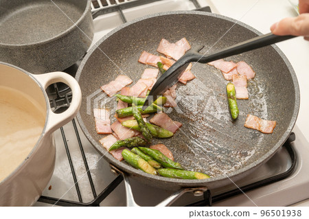 Cooking scene of frying asparagus and bacon 96501938