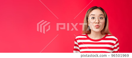 Cute pretty asian blond modern teenage girl folding lips anticipating tender romantic moment kiss, look camera wear glasses, blowing mwah, stand silly red background, feel passionate coquettish Cute pretty asian blond modern teenage girl folding lips anticipating tender romantic moment kiss, look camera wear glasses, blowing mwah, stand silly red background, feel passionate coquettish 96501969