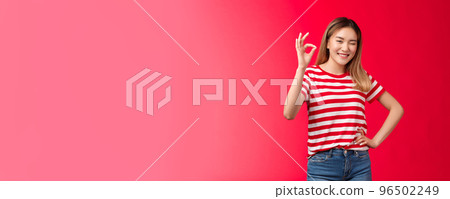 Good job mate. Proud happy female coworker approve your effort show okay gesture winking joyfully congratulate friend excellent plan, say well done make ok good approval gesture, red background 96502249