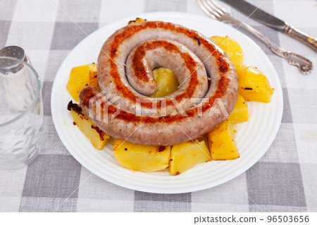 Just cooked portion of fried botifarra with potatoes 96503656