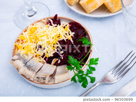 Sliced herring with grated beetroot and cheese served on table Sliced herring with grated beetroot and cheese served on table 96503699