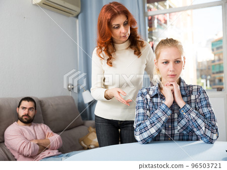 Mother comforting young daughter after a family conflict 96503721