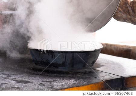 Preparation of shurpa in a cauldron on a Russian stove on an open fire. Preparation of shurpa in a cauldron on a Russian stove on an open fire. 96507468
