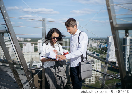 employee of a business center meets a visitor with a handshake. 96507748