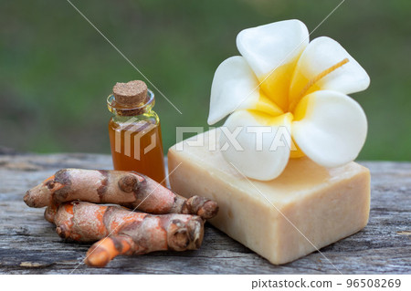 Turmeric, essential oil,bar soap and flower candle on wooden background. spa concept. Turmeric, essential oil,bar soap and flower candle on wooden background. spa concept. 96508269