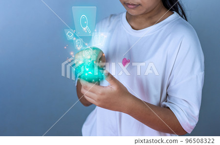 Educational concept picture. A girl stands holding an education icon representing creativity and innovation. Guidelines for searching for educational information. copy space Educational concept picture. A girl stands holding an education icon representing creativity and innovation. Guidelines for searching for educational information. copy space 96508322