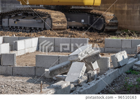Heavy machinery demolishing the roof of a house Heavy machinery demolishing the roof of a house 96510163